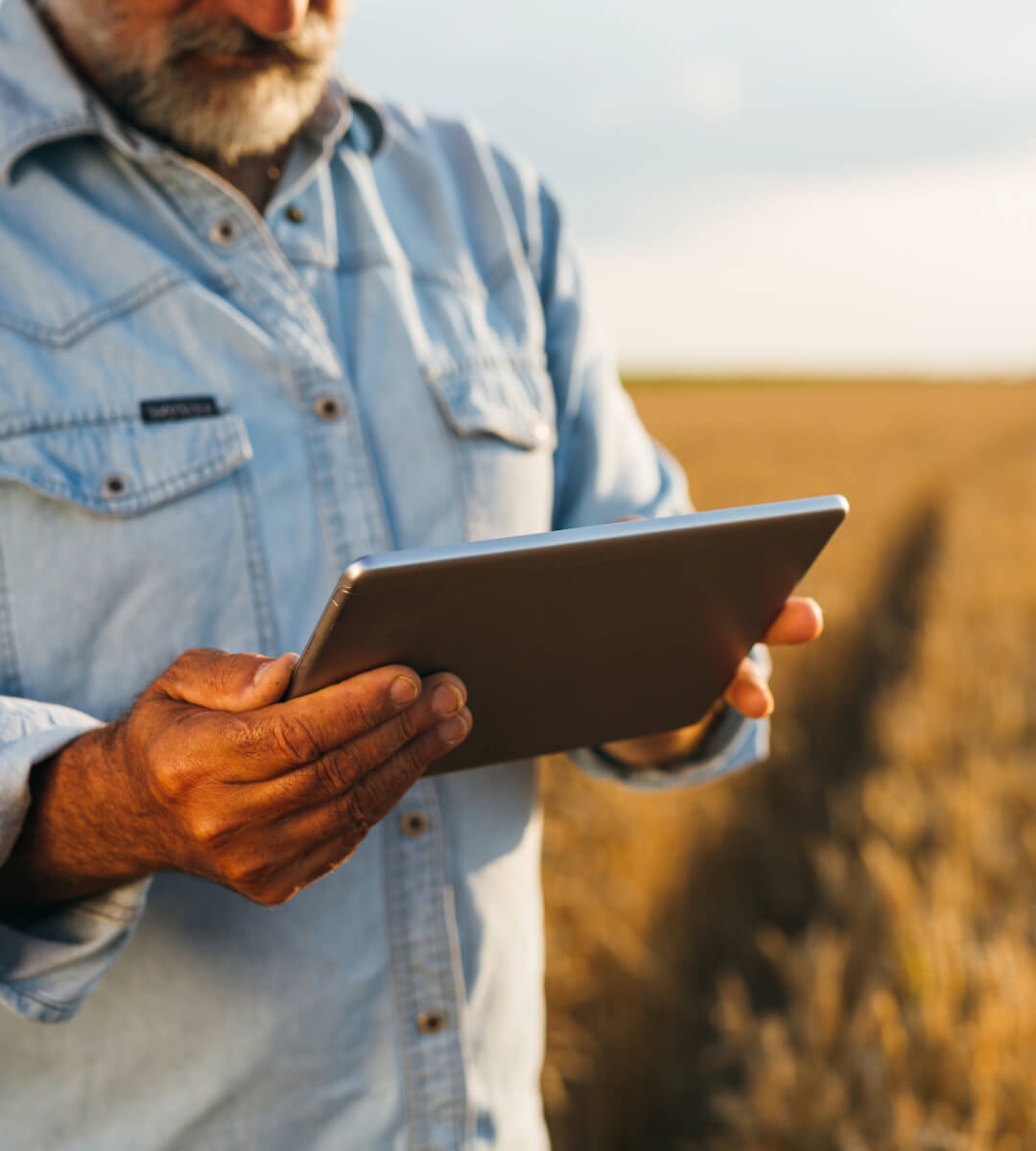 Texas Panhandle farmer man holding tablet in his field receiving high speed wireless internet service