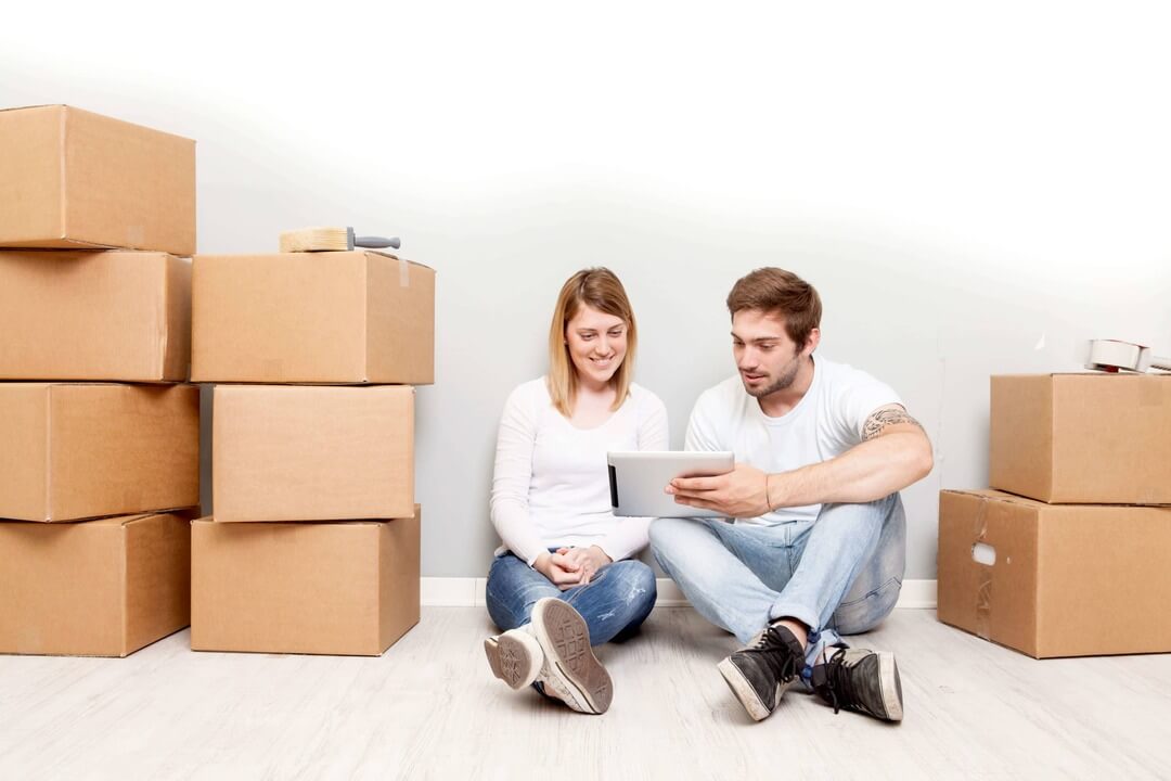 couple moving into apartment complex connected to wifi on tablet