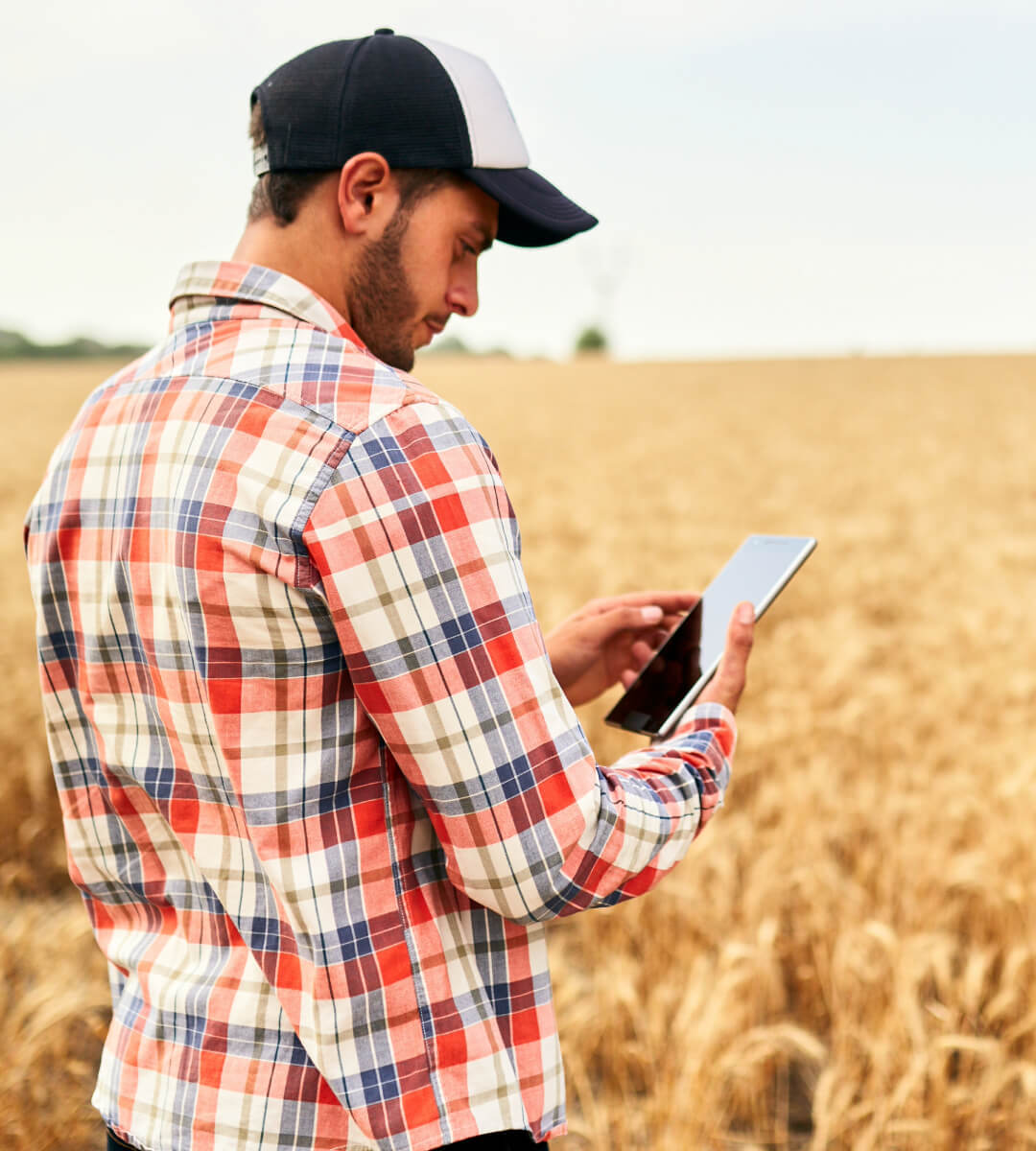 Agricultor del Texas Panhandle usando Internet de alta velocidad para su negocio en su tableta en el campo