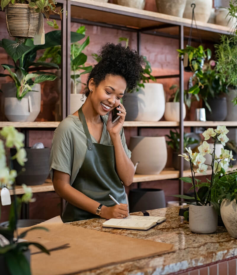 Business owner utilizing VoIP telephone and calling systems services