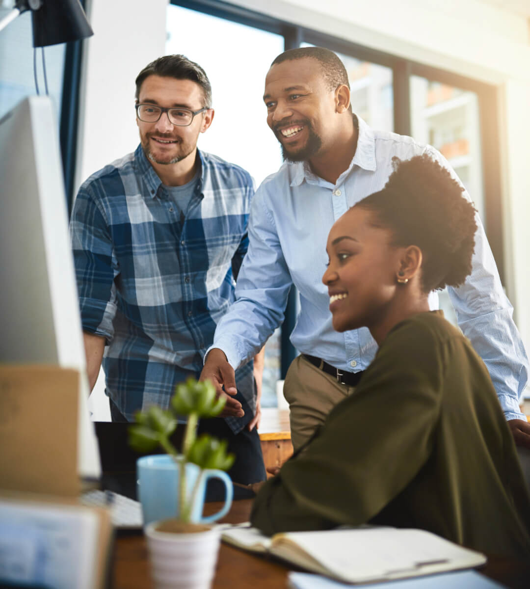 Team at small business using desktop to complete work